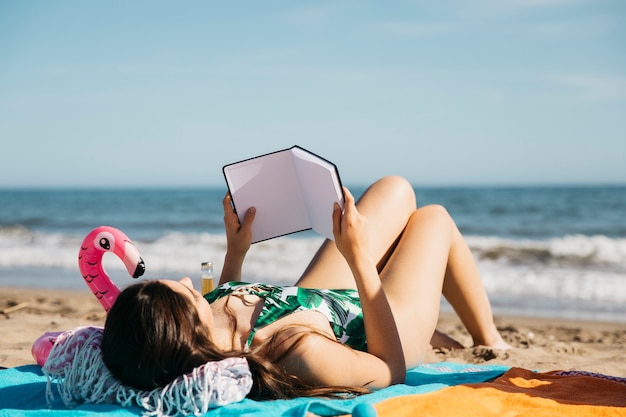 Woman reading book at the beach