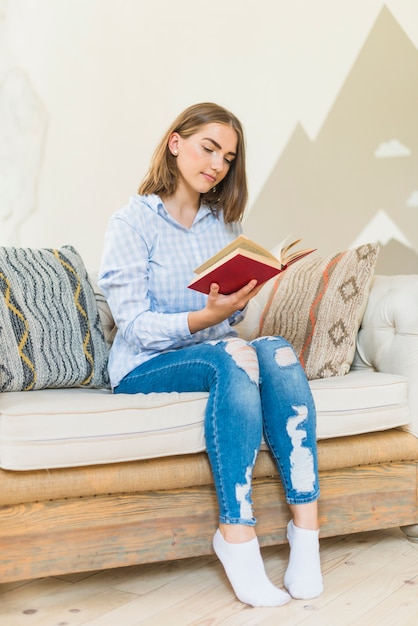 Free Photo woman reading book at home