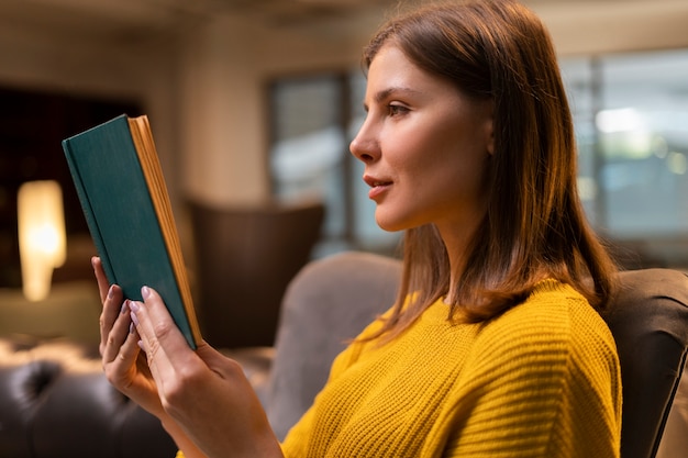 Woman reading indoors medium shot