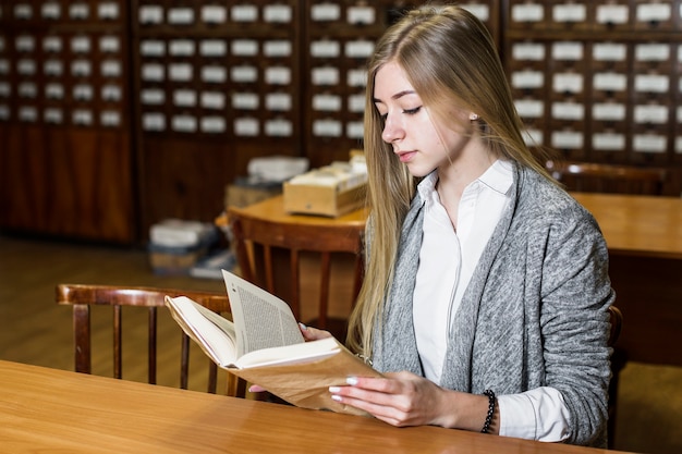 Free photo woman reading at library table