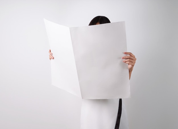 Free photo woman reading mockup of blank newspapers to add your own news isolated on white background