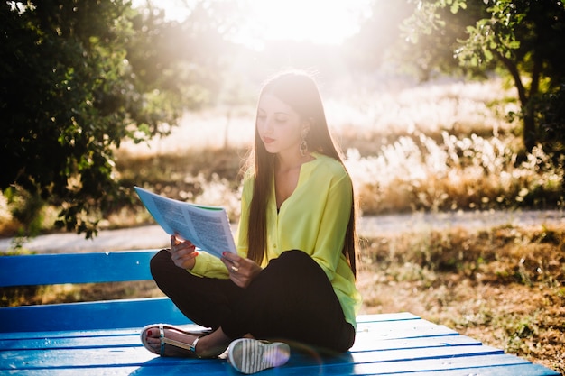 Free photo woman reading papers in park