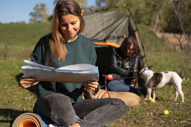 Woman reading and puppy playing with her friend