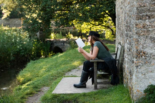 Free Photo woman reading while traveling alone