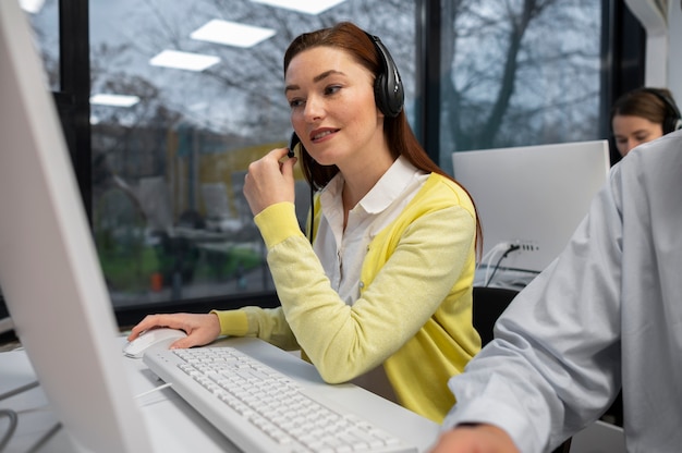 Free Photo woman receiving calls during work in a call center