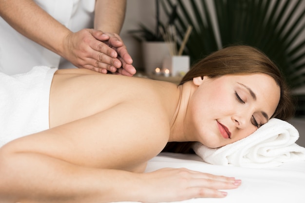 Woman receiving massage in spa center