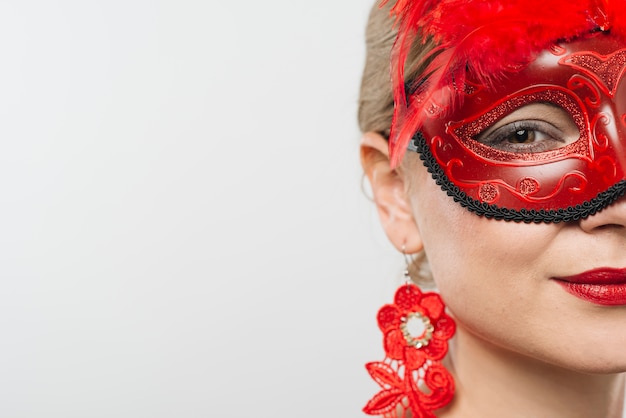 Woman in red carnival mask 