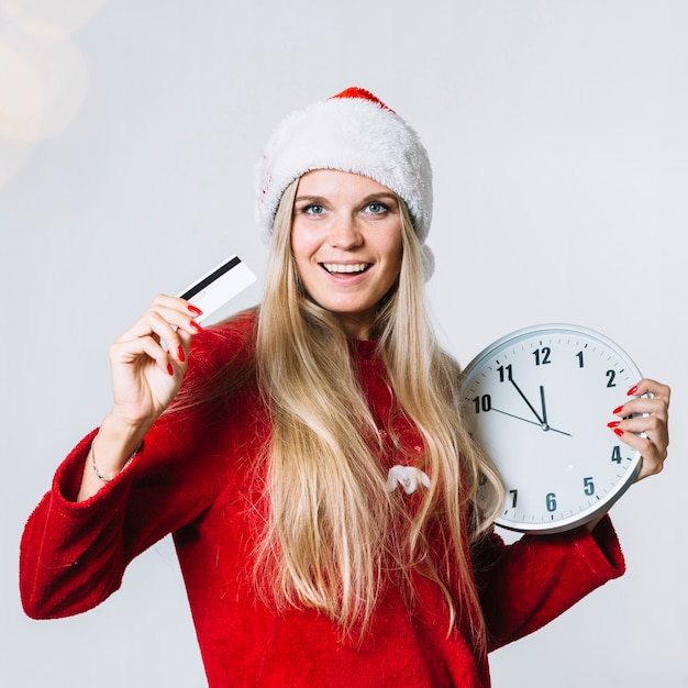 Woman in red clothes with clock and card