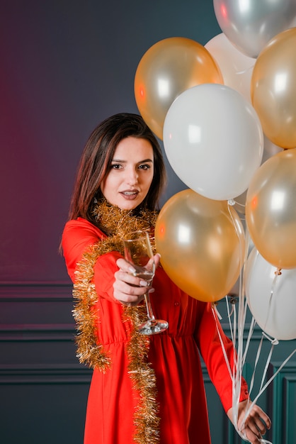 Woman in red dress with champagne glass