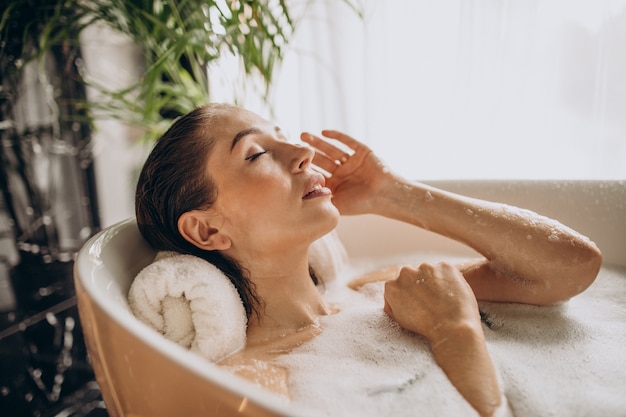 Woman relaxing in bath with bubbles