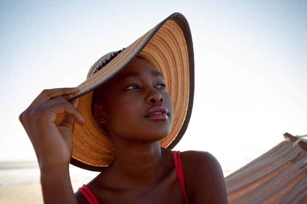 Woman relaxing in a hammock on the beach