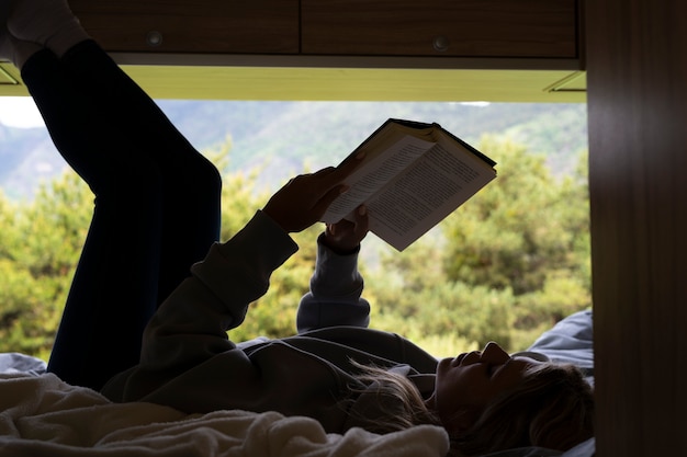 Free photo woman relaxing in her camper in daylight