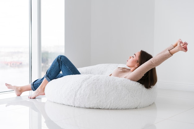 Woman relaxing and looking  through the window