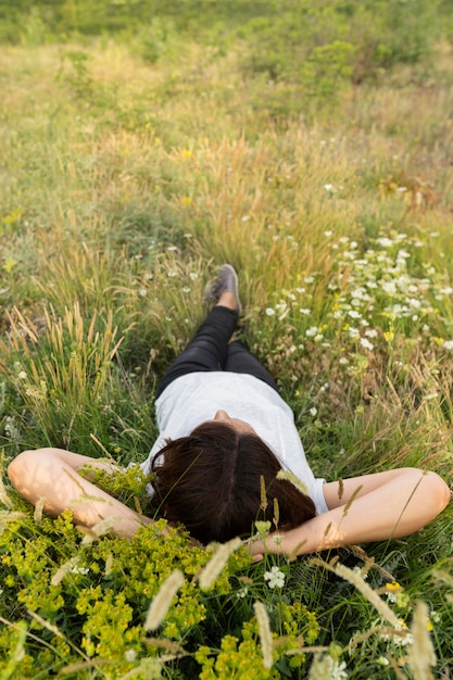 Free photo woman relaxing in nature on grass