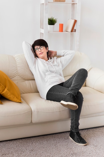 Free photo woman relaxing on sofa at home