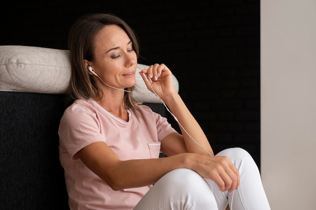 Woman relaxing while listening to music at home