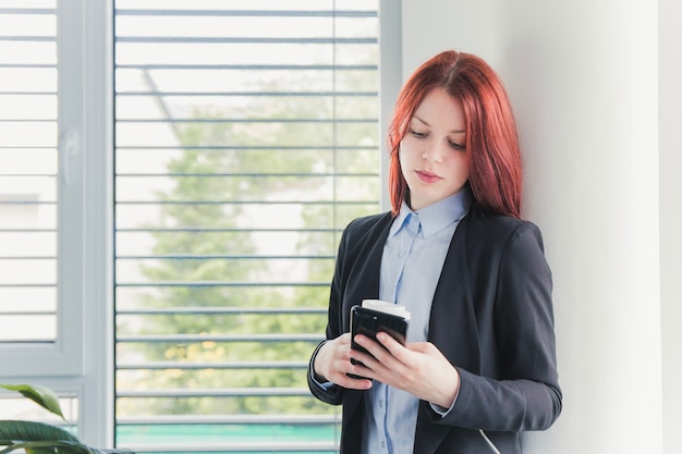 Woman relaxing with coffee and phone