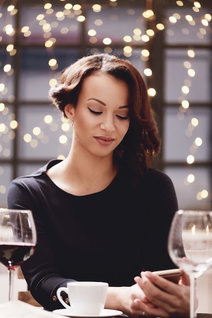 Woman in restaurant holding a wine glass