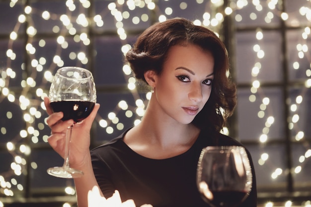 Woman in restaurant holding a wine glass