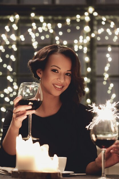 Woman in restaurant holding a wine glass