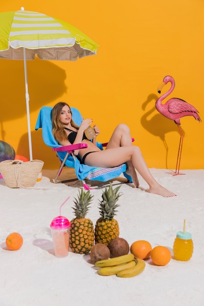 Woman resting in deckchair on beach