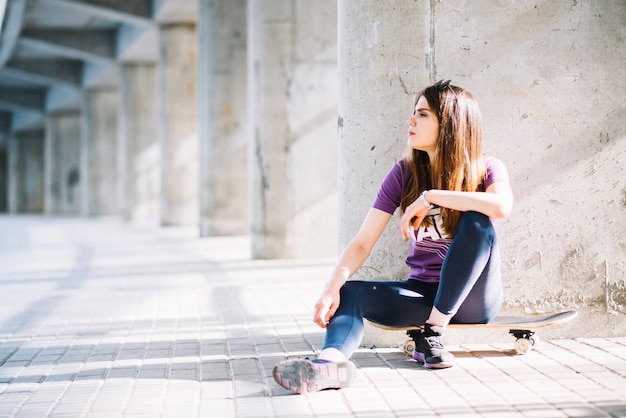 Free photo woman resting on skateboard