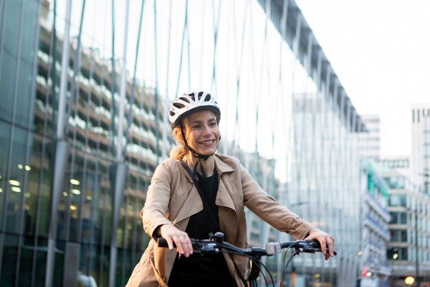 Woman riding a bike while wearing her helmet