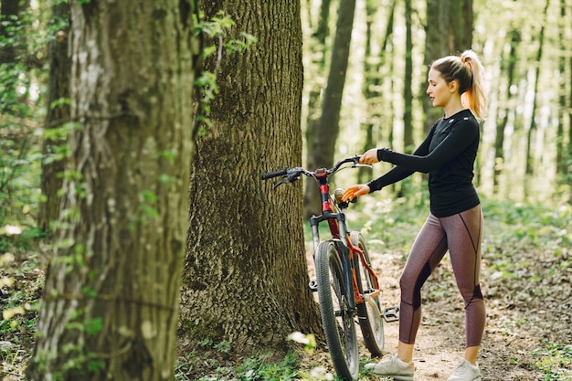 Woman riding a mountain bike in the forest