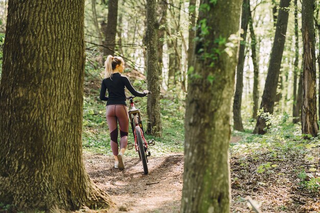 Woman riding a mountain bike in the forest