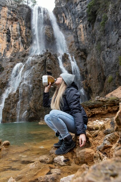 Woman at river drinking water