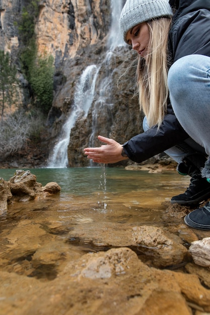 Woman at river washing hands