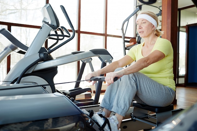 Woman rowing in gym