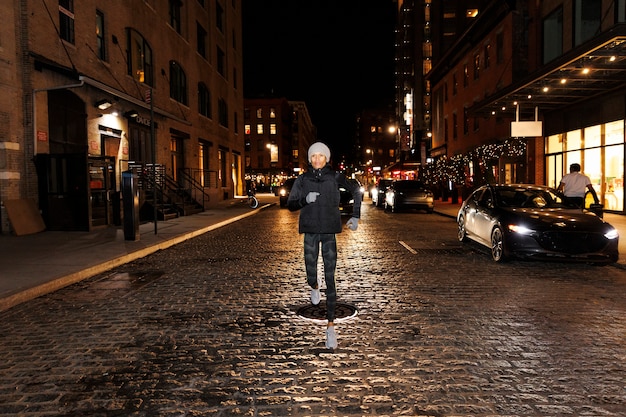 Free photo woman running at night in the city streets