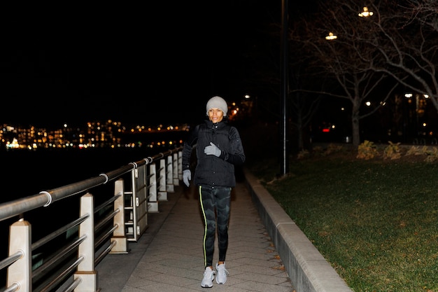 Woman running at night in the city