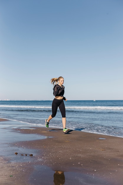 Woman running at shoreline