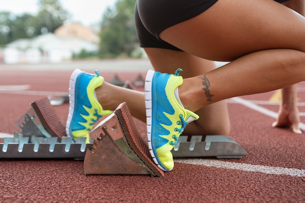 Free photo woman at running starting line side view