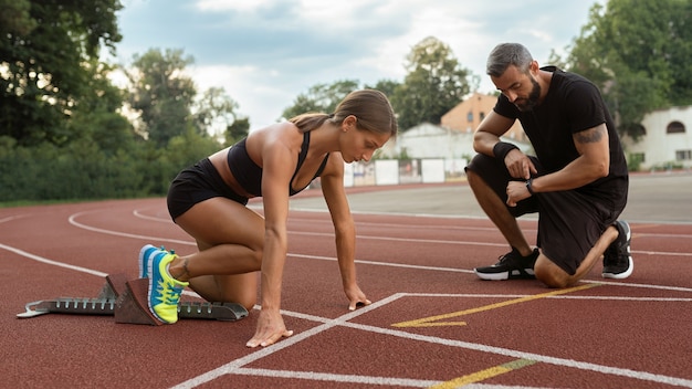 Free Photo woman at running starting line side view