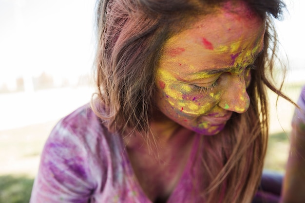 Free Photo woman's face covered with holi color