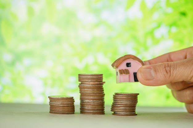 Free Photo woman's hand holding small house