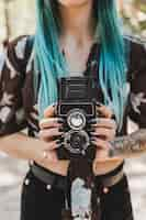 Free photo woman's hand holding twin lens reflex old photo camera