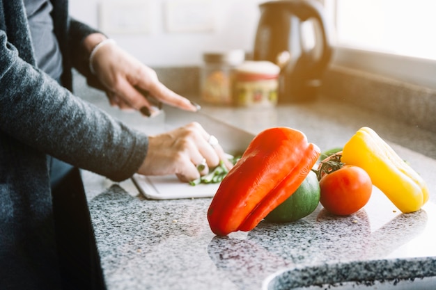 Free Photo woman's hand near fresh vegetables on kitchen counter