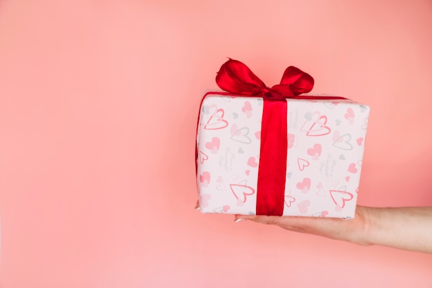 Woman's hand with present box 