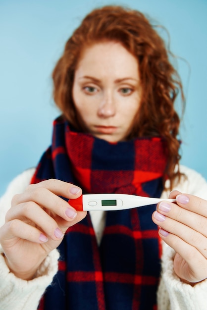 Free Photo woman's hands holding digital thermometer