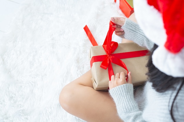 Free photo woman's hands is opening christmas present