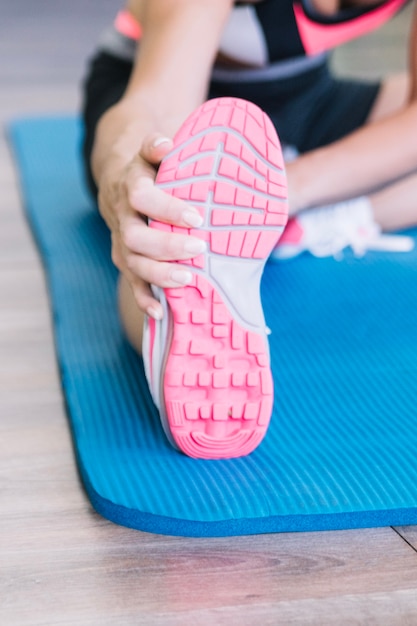 Woman's sneaker on mat