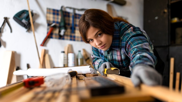 Free photo woman scraping wood planks