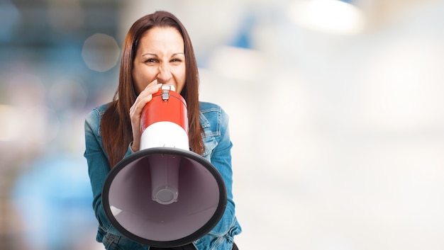 Free photo woman screaming through a megaphone