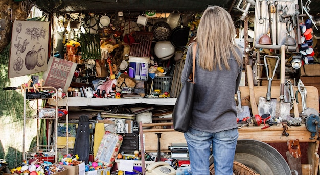 Free photo woman searching for something to buy in an antiques market