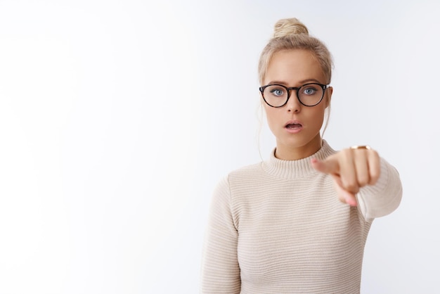 woman seeing celebrity standing in stupor and frustration pointing at camera