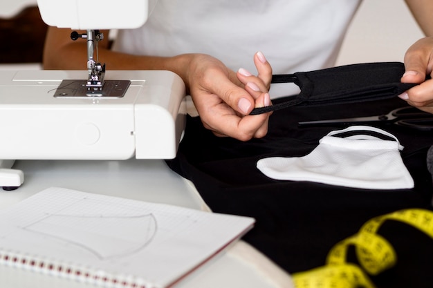 Woman sewing face mask out of textile